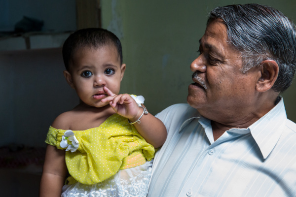 Khalil Ahmad plays with his granddaughter